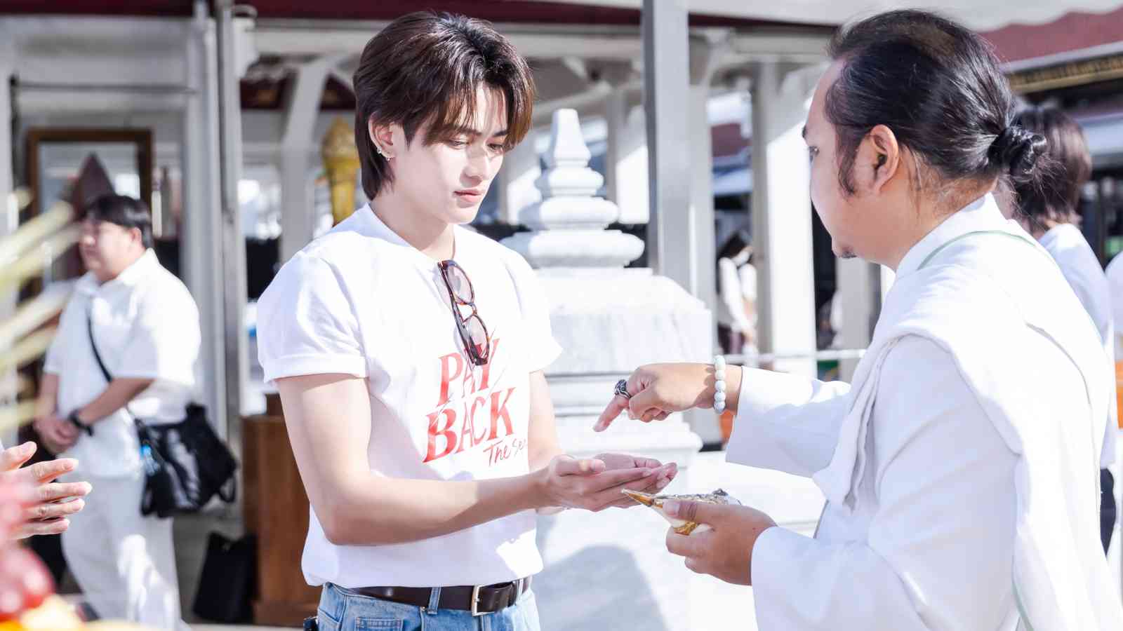 Paramee Thesdaroon aka "Shogun" wearing a Payback Series t-shirt and receiving blessings from a monk