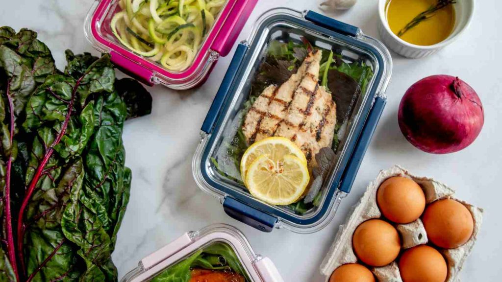 Examples of meal prep showing salad, eggs and meat for protein, and assorted vegetables