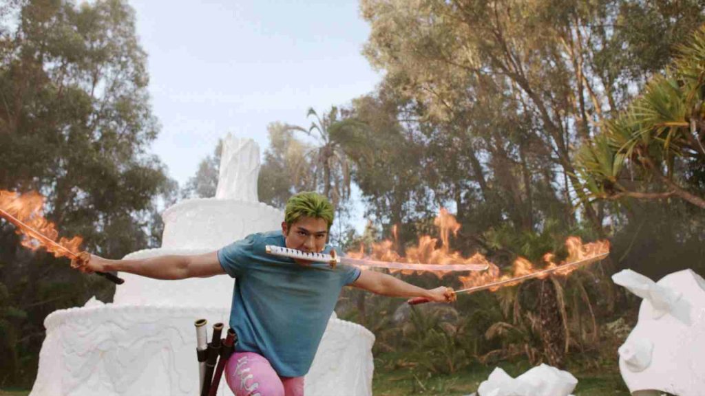 Mackenyu playing Zoro who wields three flaming swords in One Piece live action Season 2 Episode 5 "Wax on Wax off"