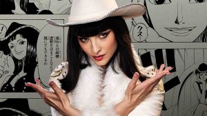 Miss All Sunday actress Lera Abova in the One Piece live action season 2 poster, showing Nico Robin's manga panels in the background.