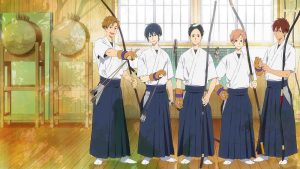 Tsurune anime characters Seiya Takehaya, Minato Narumiya, Ryouhei Yamanouchi, Nanao Kisaragi, and Kaito Onogi standing in a practice room holding bows and arrows.