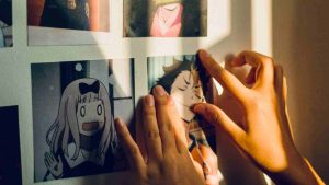 Fan putting up an anime Haikyuu print of Yu Nishinoya on their wall