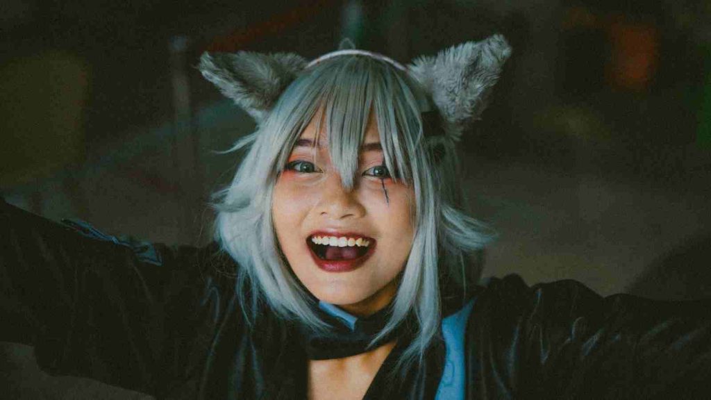 Asian female cosplayer attending ACG Event with furry ears and silver wig