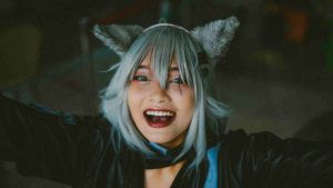 Asian female cosplayer attending ACG Event with furry ears and silver wig
