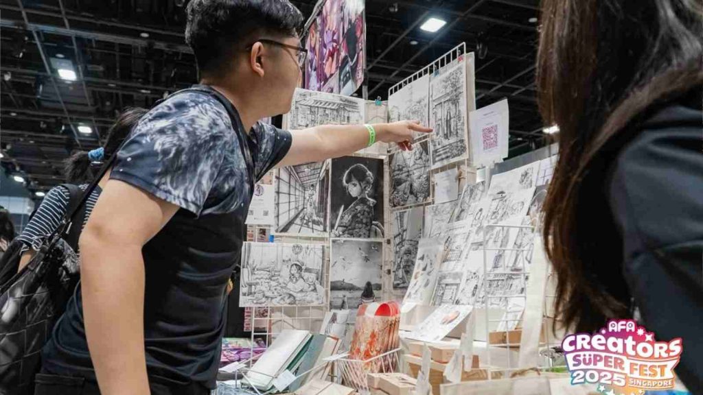 Man buying art at Creator Super Fest 2025 booth