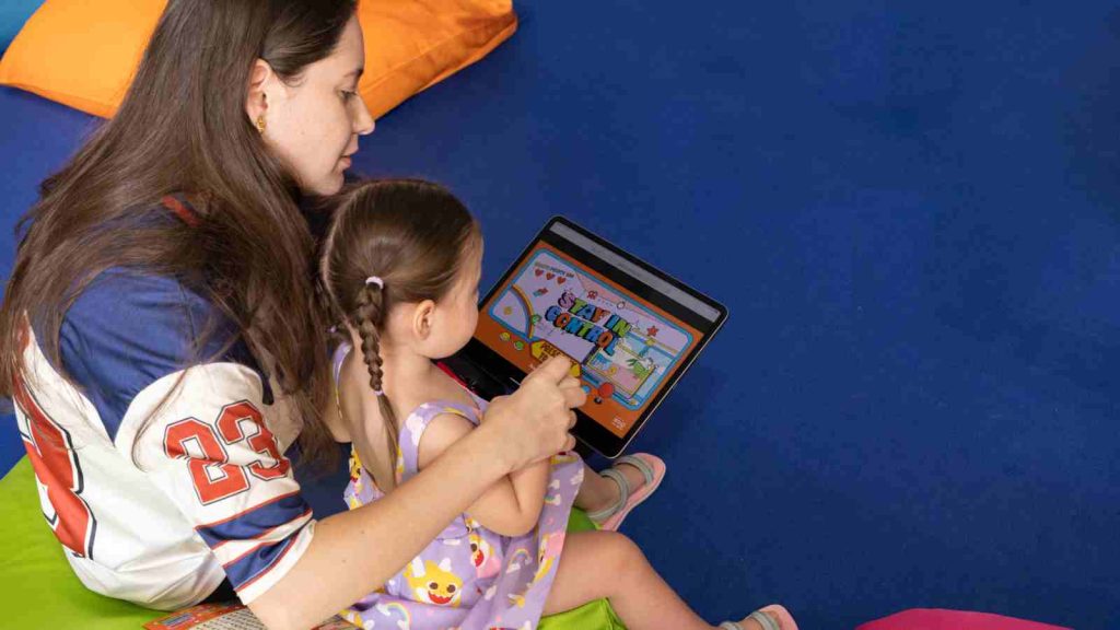 Mother and child playing a game on iPad during Healthy Digital Play event