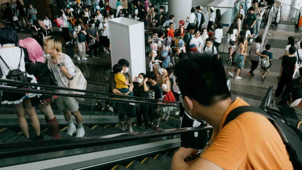A crowd of people going up and down an escalator at Animation-Comic-Game Hong Kong 2023.