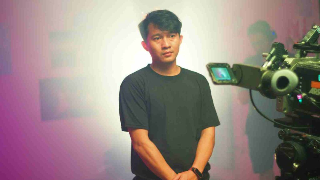 Asian actor standing ready for filming in front of the camera