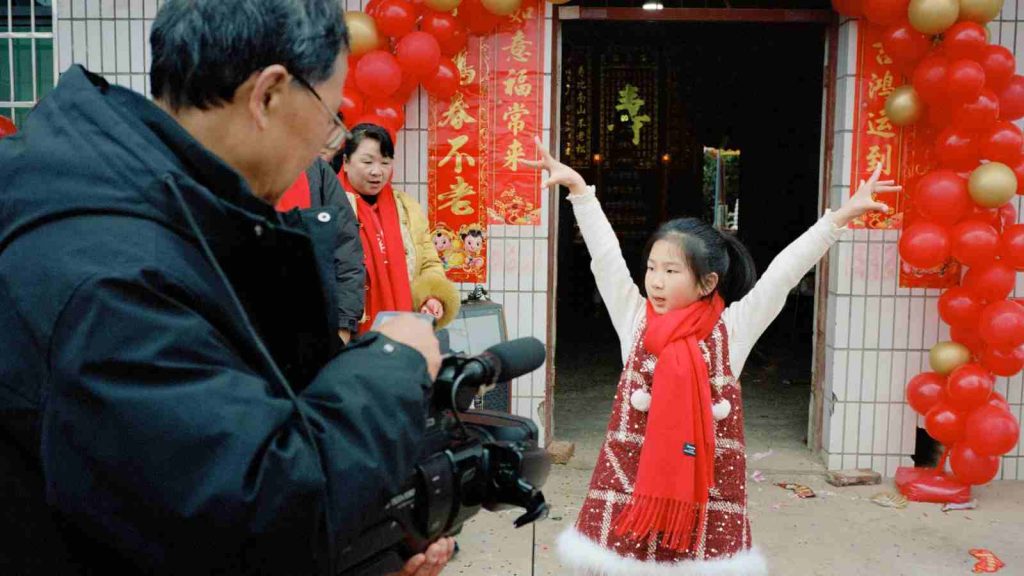 Cameraman films young Chinese girl during Chinese new Year