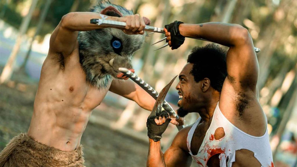 Cosplayers of Inosuke Hashibira from Demon Slahyer and Wolverine from X-Men fighting each other.