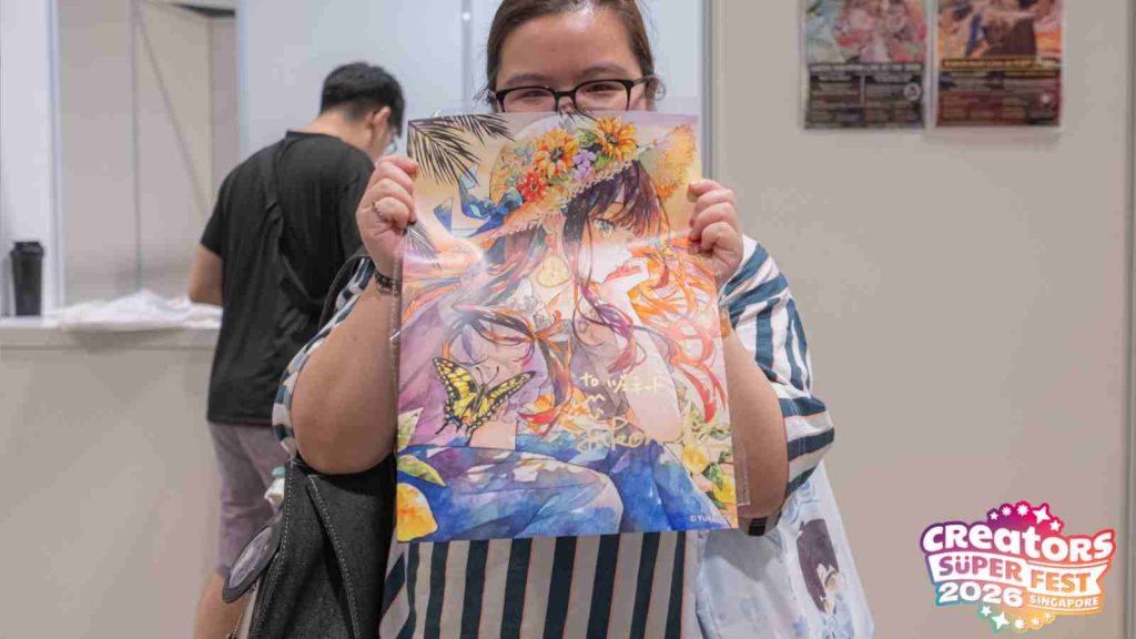 AFA CSF 2026 attendee holding up a signed print from artist Yukoring at AFA CSF 2026