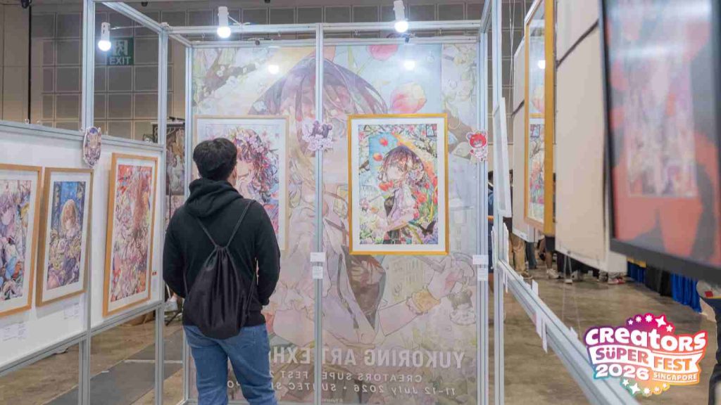 AFA CSF 2026 attendee looking at Japanese artist Yukoring's exhibition panel