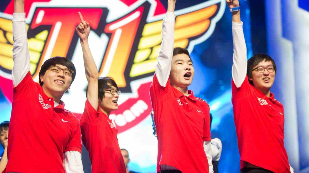 Winners SKT T1 Bae "Bengi" Seong-woong, Lee "Faker" Sang-hyeok, Chae "Piglet" Gwang-jin, and Lee "PoohManDu" Jeong-hyeon doing the T1 pose on stage after winning the Worlds 2013 championship