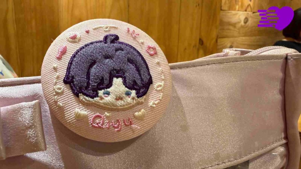 Love and Deepspace's Rafayel official cloth badge pinned on Melissa's handbag