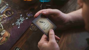 Close-up of a man holding a card for a board game.