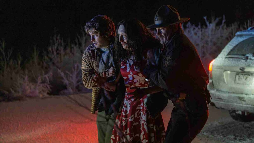 Bryan and a police officer from Racoon City helping an infected woman that he hit with his car in Resident Evil movie 2026