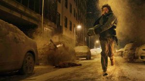 Bryan running on the streets of Racoon City as zombies fall from the buildings around him in Resident Evil 2026 movie